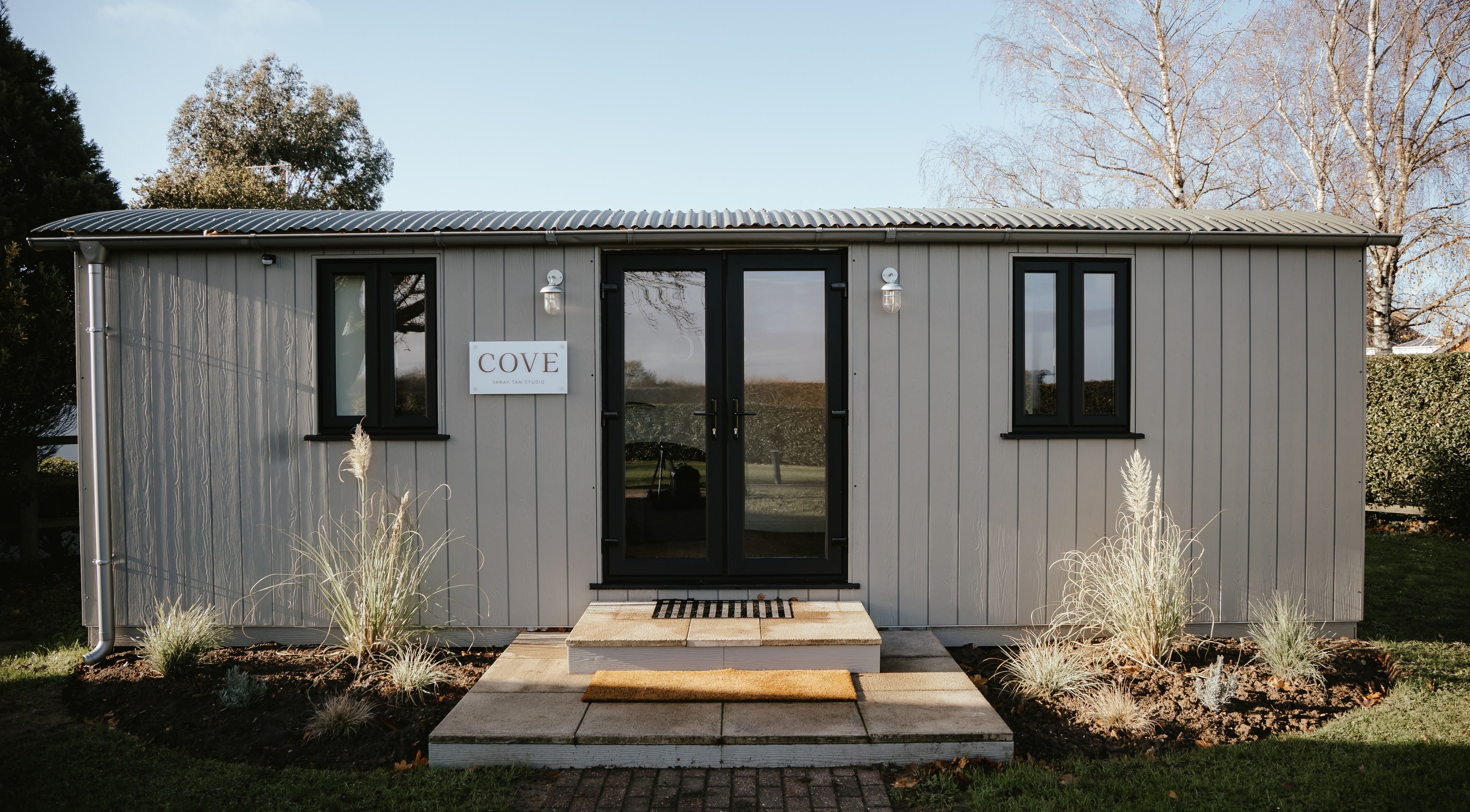 Entrance of COVE - Spray Tan Studio in Hethersett, England showcasing modern facade and welcoming design.