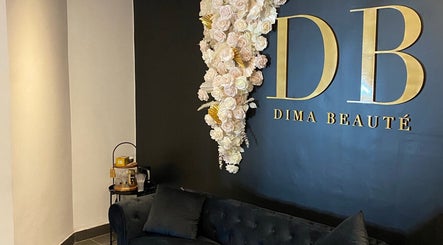 Elegant lounge at DIMA FACES, Longueuil, Québec, CA, featuring plush seating and floral wall decor.