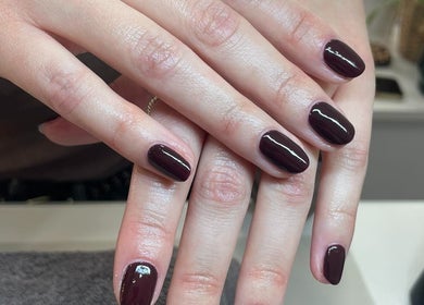 Elegant manicured dark plum nails at Radiant by Rosie in Bradford, England, GB.
