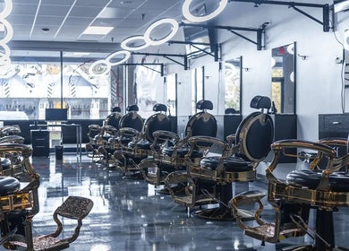 Sophisticated salon setup at London Clippers, Lake Zurich, Illinois, US. Elegant black and gold styling chairs.
