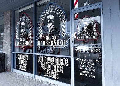 London Clippers storefront in Lake Zurich, Illinois, US with barber service signs.