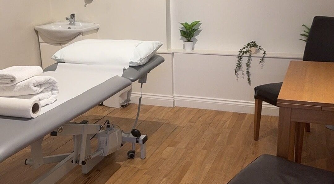 Relaxing treatment room at Rehab Joy with a massage table, London, England, GB. Modern decor enhances the ambiance.