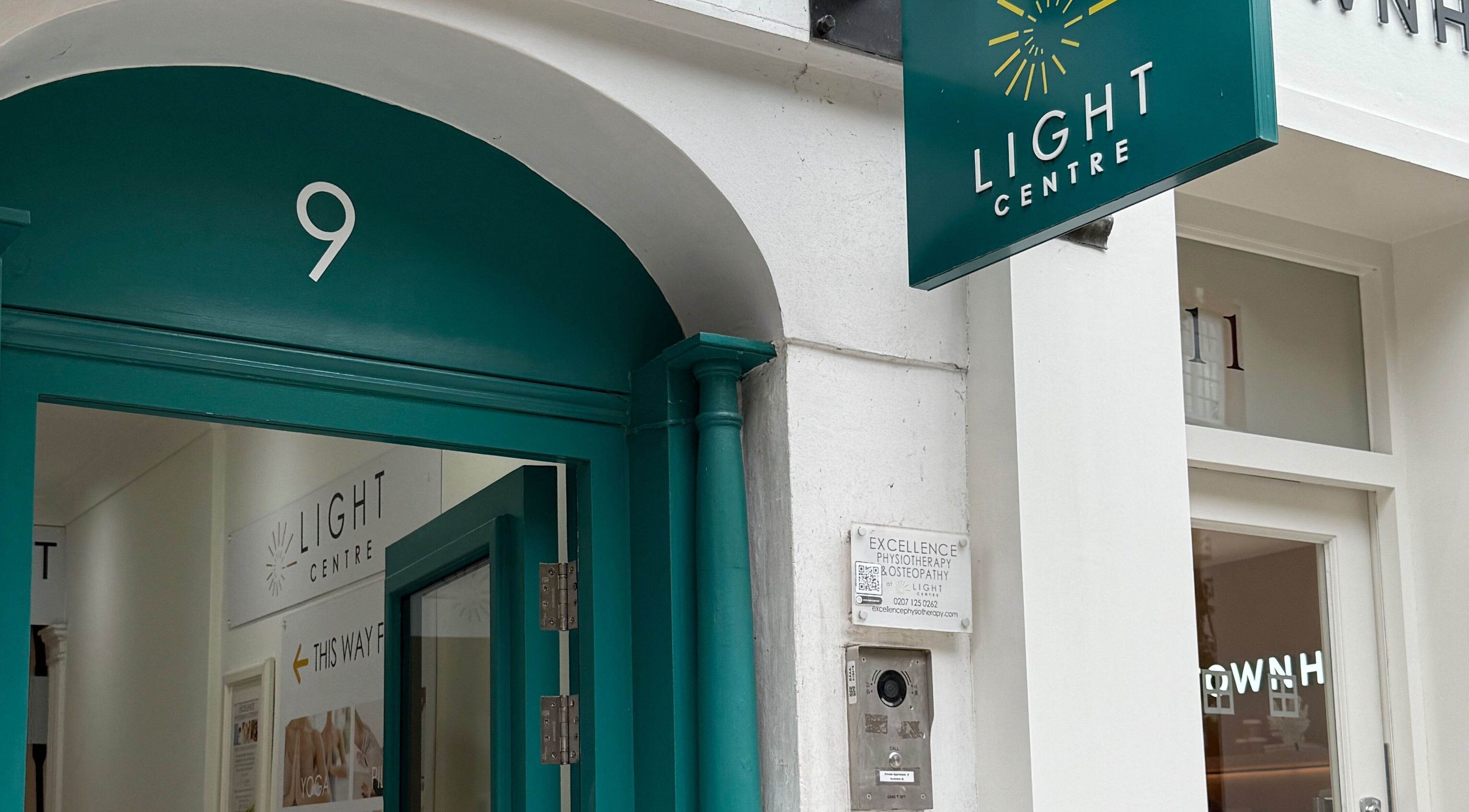 Entrance of Rehab Joy, London, England, GB with signage and glass doors.
