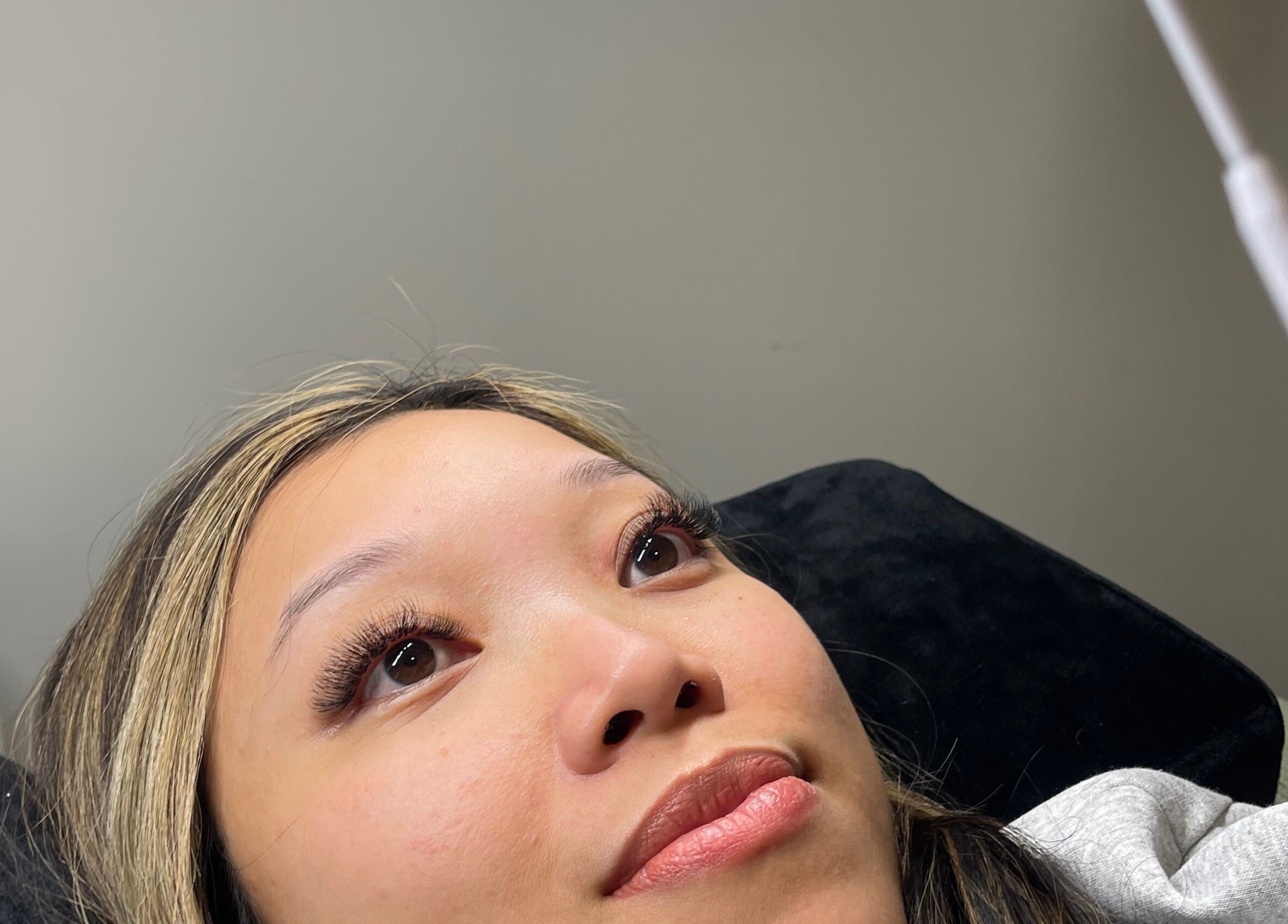 Client with beautifully enhanced lashes at Beautybyjmn, Holmview, Queensland, AU. Glowing beauty and relaxation.