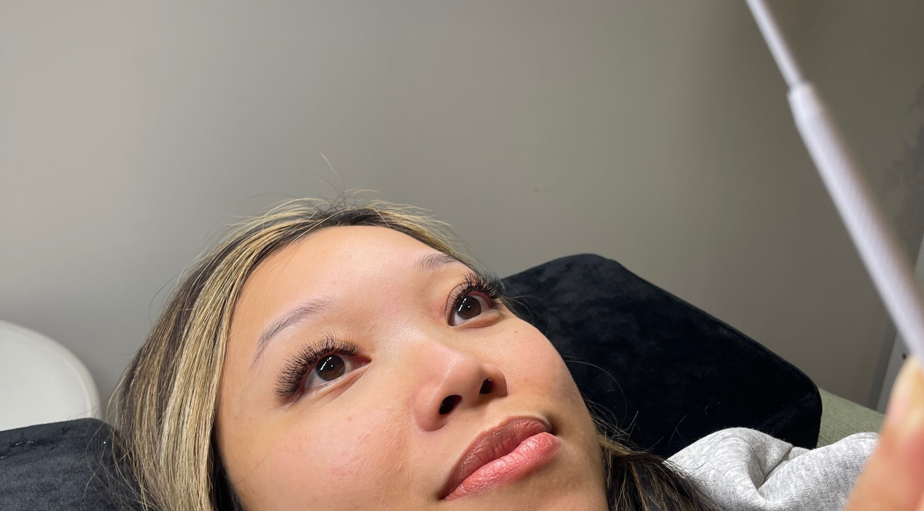 Client with beautifully enhanced lashes at Beautybyjmn, Holmview, Queensland, AU. Glowing beauty and relaxation.