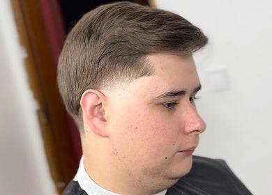 Close-up of a stylish haircut at AMPBARBERSHOP in Lisboa, Lisboa, PT showcasing a smooth fade.