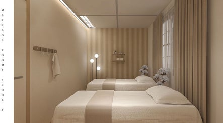Relaxing massage room at Ayawellnesshouse, Melbourne, Victoria, AU, featuring twin beds and soft lighting.