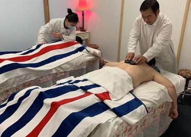 Massage therapy session at Easy Garden Relaxation in Columbus, Ohio, US, featuring hot stone technique.