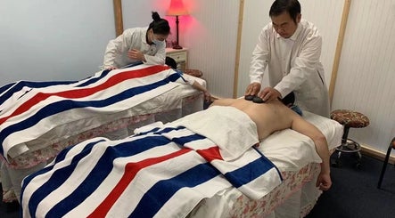 Massage therapy session at Easy Garden Relaxation in Columbus, Ohio, US, featuring hot stone technique.