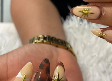 Elegant nail art with gold accents at Tjizaa Beauty Haven, Windhoek, Khomas Region, NA.
