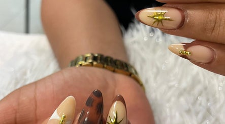 Elegant nail art with gold accents at Tjizaa Beauty Haven, Windhoek, Khomas Region, NA.