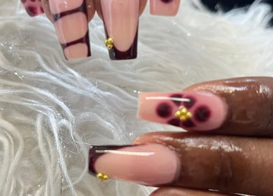 Elegant nail art design at Tjizaa Beauty Haven, Windhoek, Khomas Region, NA with intricate patterns and gold accents.