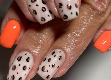 Stylish leopard and orange nails at Dandelion Beauty in Bethal, Mpumalanga, ZA.