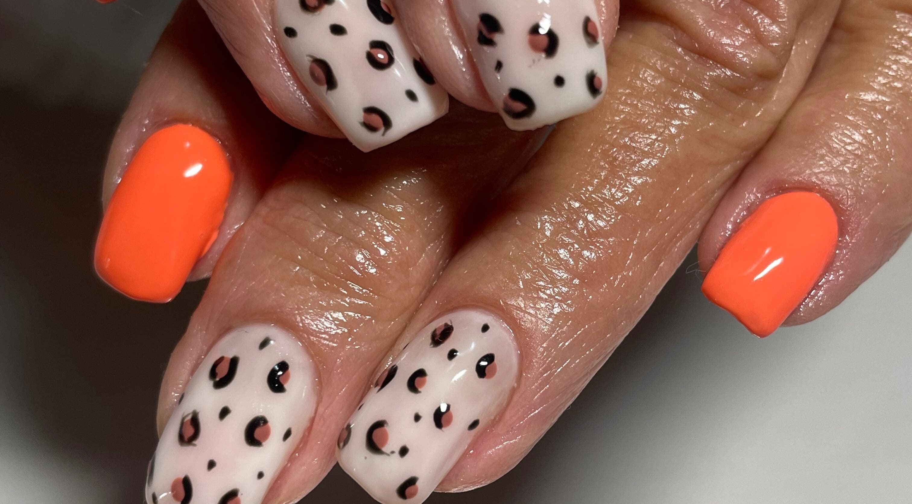 Stylish leopard and orange nails at Dandelion Beauty in Bethal, Mpumalanga, ZA.