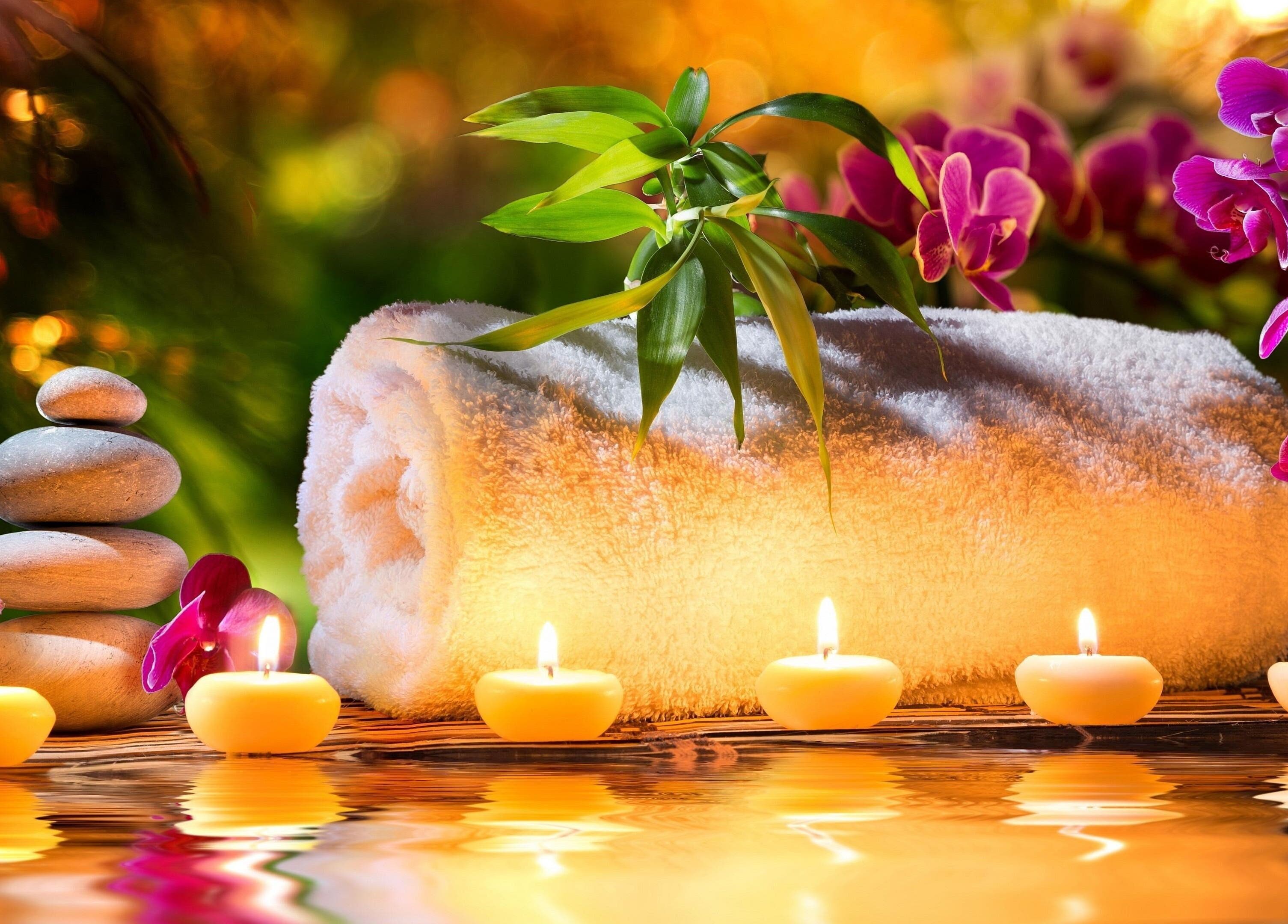 Serene spa setup with candles and orchids at CS Sanctuary Wellness Spa, Plantation, Florida, US.
