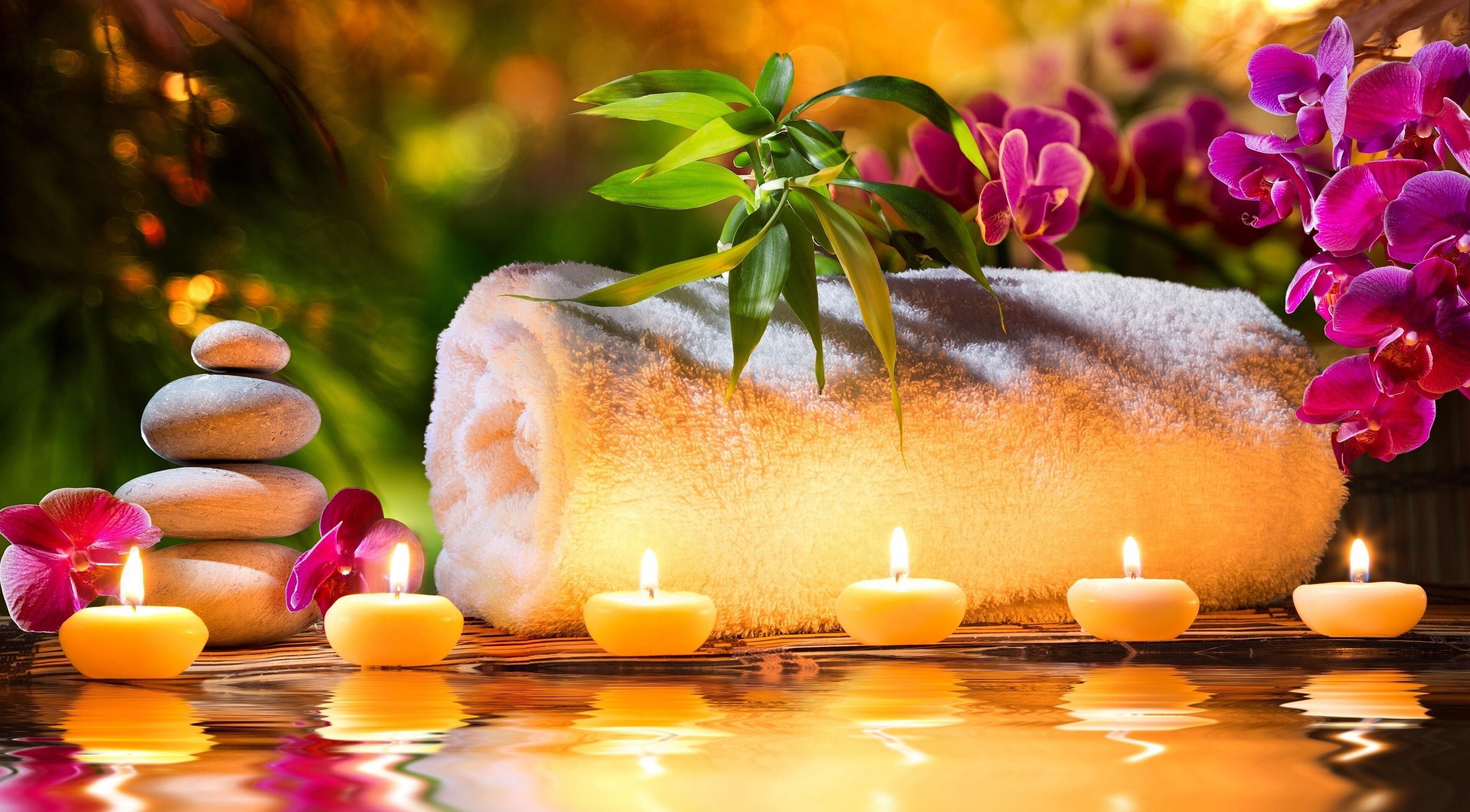 Serene spa setup with candles and orchids at CS Sanctuary Wellness Spa, Plantation, Florida, US.