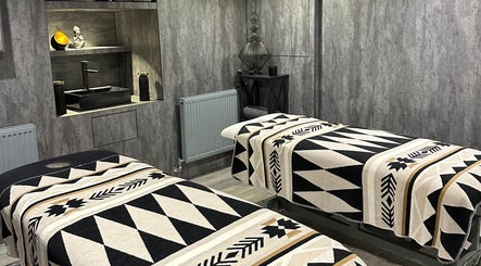 Relaxing massage room at ND Skin Clinic, Prestwich, England, GB with twin treatment beds and elegant decor.