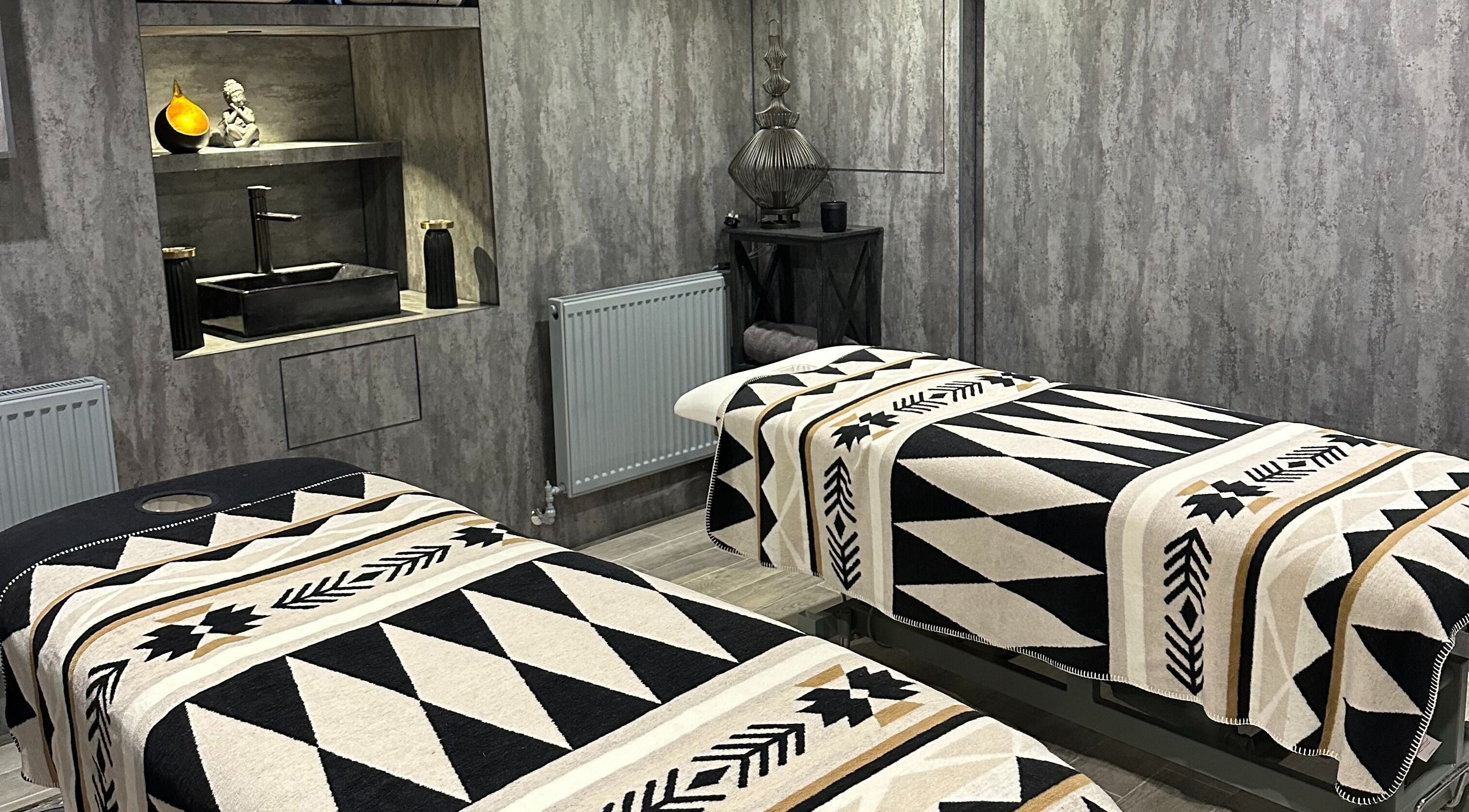 Tranquil therapy room at ND Skin Clinic, Prestwich, England, GB with twin massage tables and soothing decor.