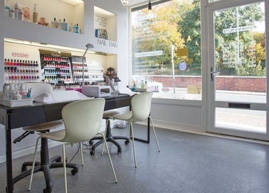 Chic nail bar at ND Skin Clinic, Prestwich, England, GB, showcasing vibrant polish selection and cozy seating.