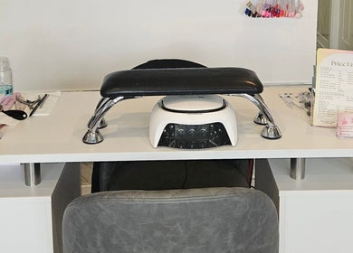 Modern nail station setup at SummerLily Nails in Rainhill, England, GB, with tools and price list displayed.