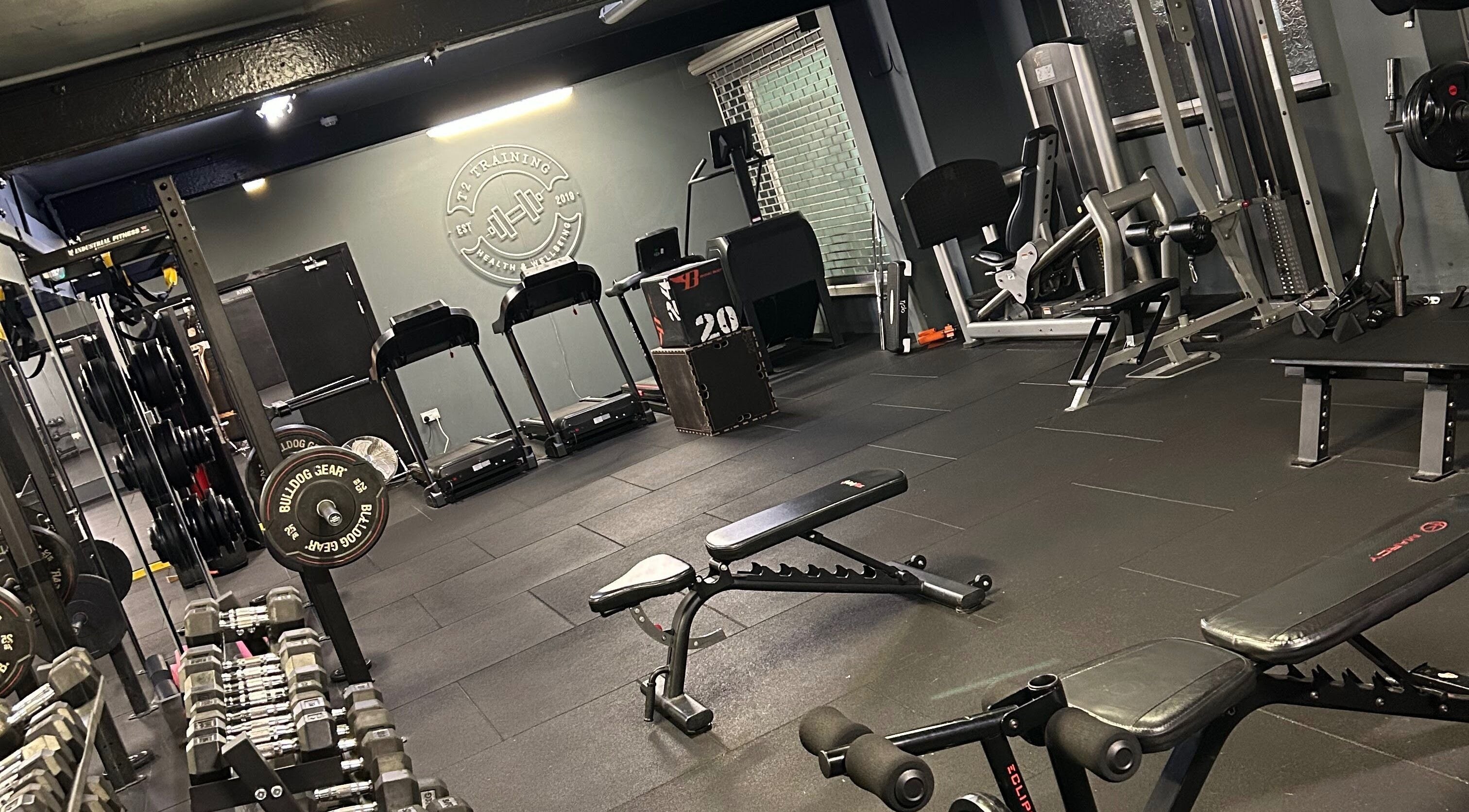 Modern gym with free weights at ProBuild Physiotherapy, Neath, Wales, GB showcasing workout equipment.