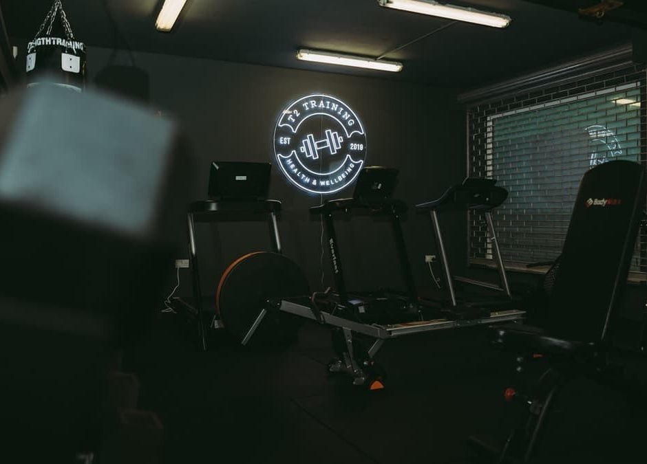 ProBuild Physiotherapy gym setup in Neath, Wales, GB showcasing fitness equipment and neon logo.