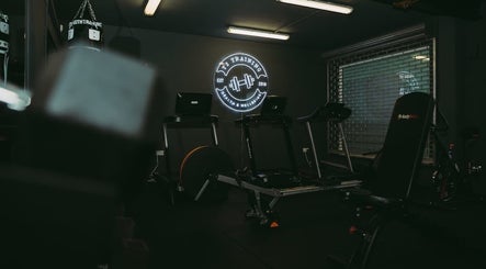 ProBuild Physiotherapy gym setup in Neath, Wales, GB showcasing fitness equipment and neon logo.