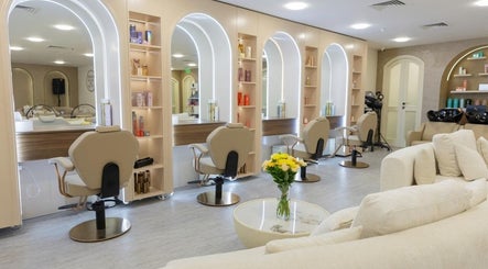 Interior of Maison Palkè Luxury Ladies Salon in Dubai, Dubai, AE, featuring chic styling stations and plush seating.