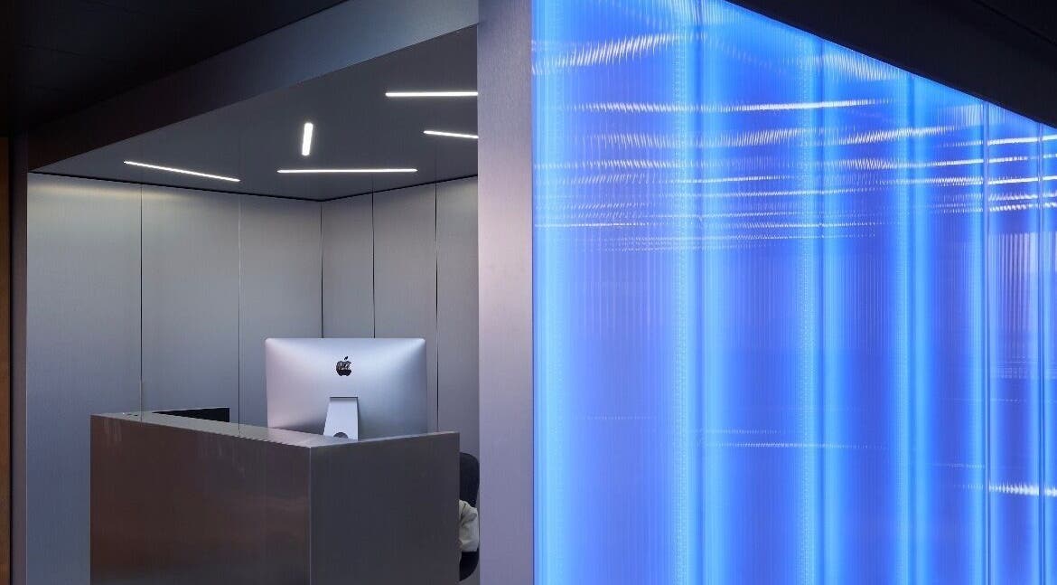 Sleek reception desk with blue lighting at Matheos Carvalho, Lisboa, Lisboa, PT.