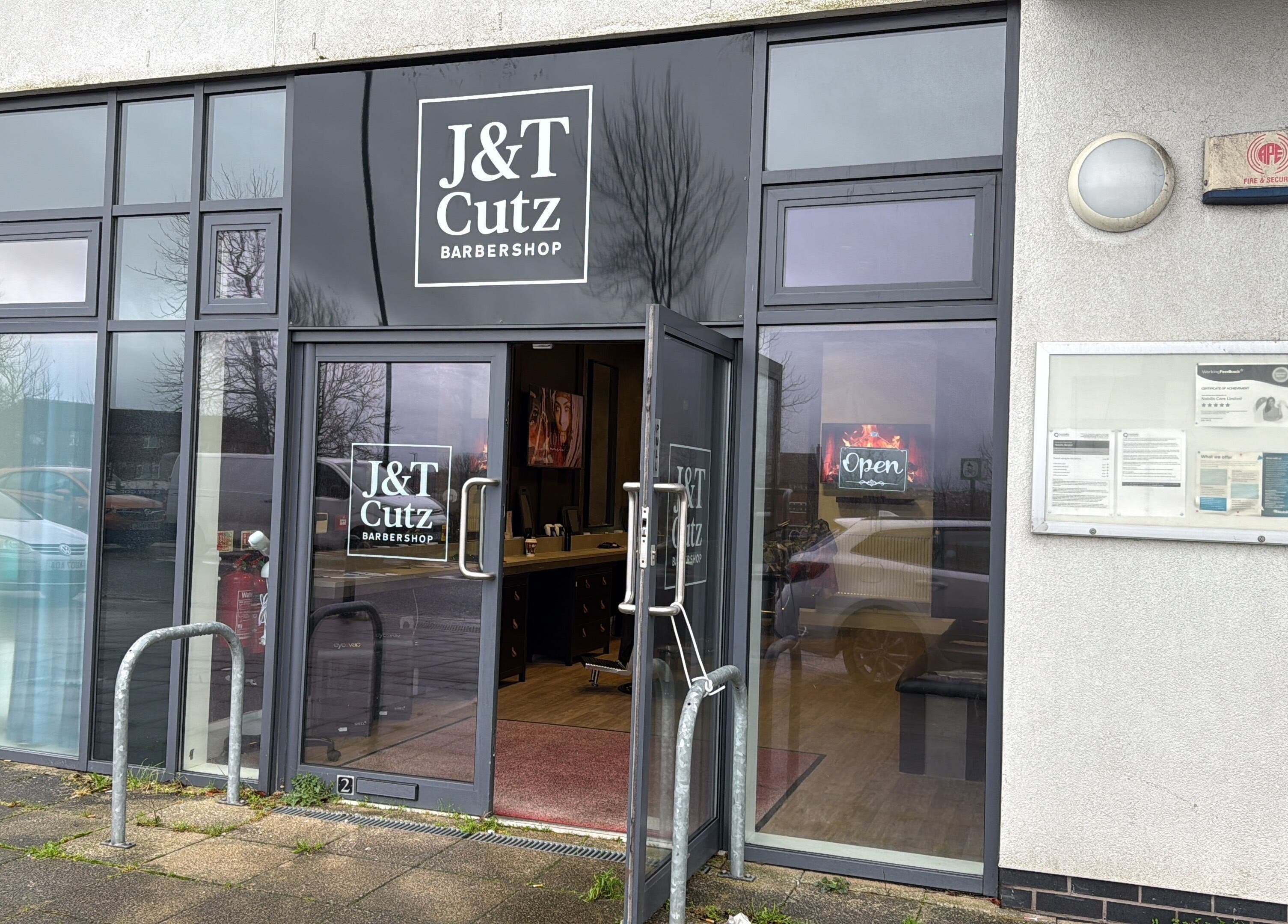 Front view of J&T Cutz LTD barbershop in Bristol, England, GB, showcasing stylish entrance.