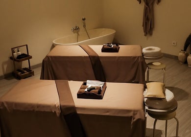 Tranquil massage room at Kama Spa, Daerah Khusus Ibukota Jakarta, ID, featuring cozy treatment beds and calming decor.