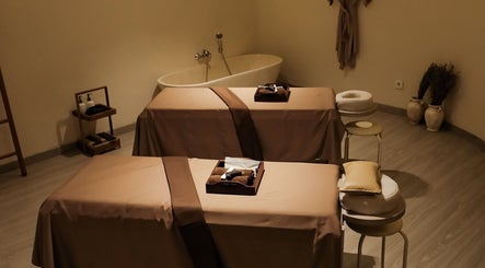Tranquil massage room at Kama Spa, Daerah Khusus Ibukota Jakarta, ID, featuring cozy treatment beds and calming decor.