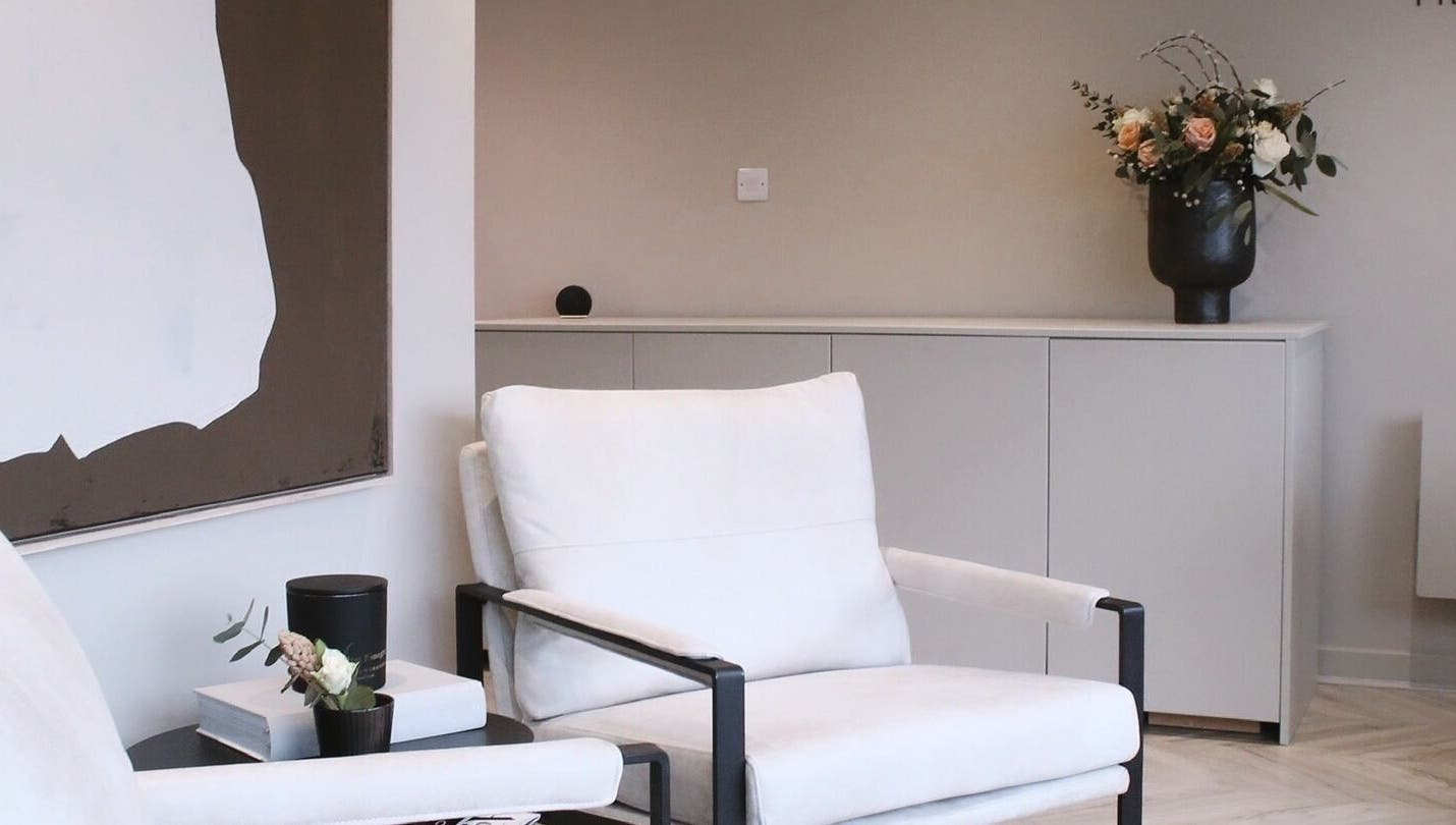 A cozy seating area at Jean Walker PMU, Harrogate, England, GB, featuring elegant decor and floral arrangement.