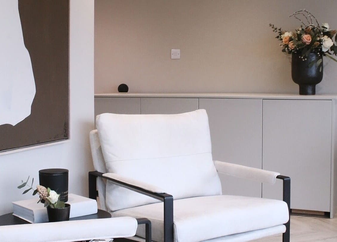 A cozy seating area at Jean Walker PMU, Harrogate, England, GB, featuring elegant decor and floral arrangement.