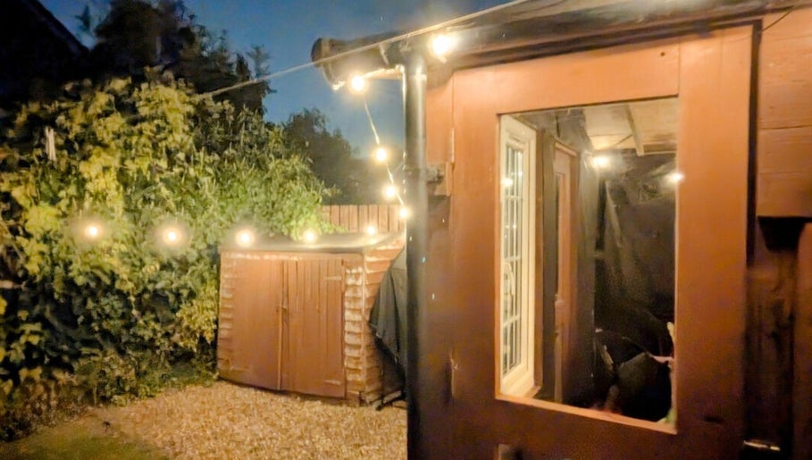 Garden Nail Haven's cozy outdoor area with string lights in Chester, England, GB.