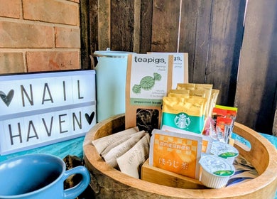 Tea and snack display at Garden Nail Haven, Chester, England, GB, creates a welcoming atmosphere.