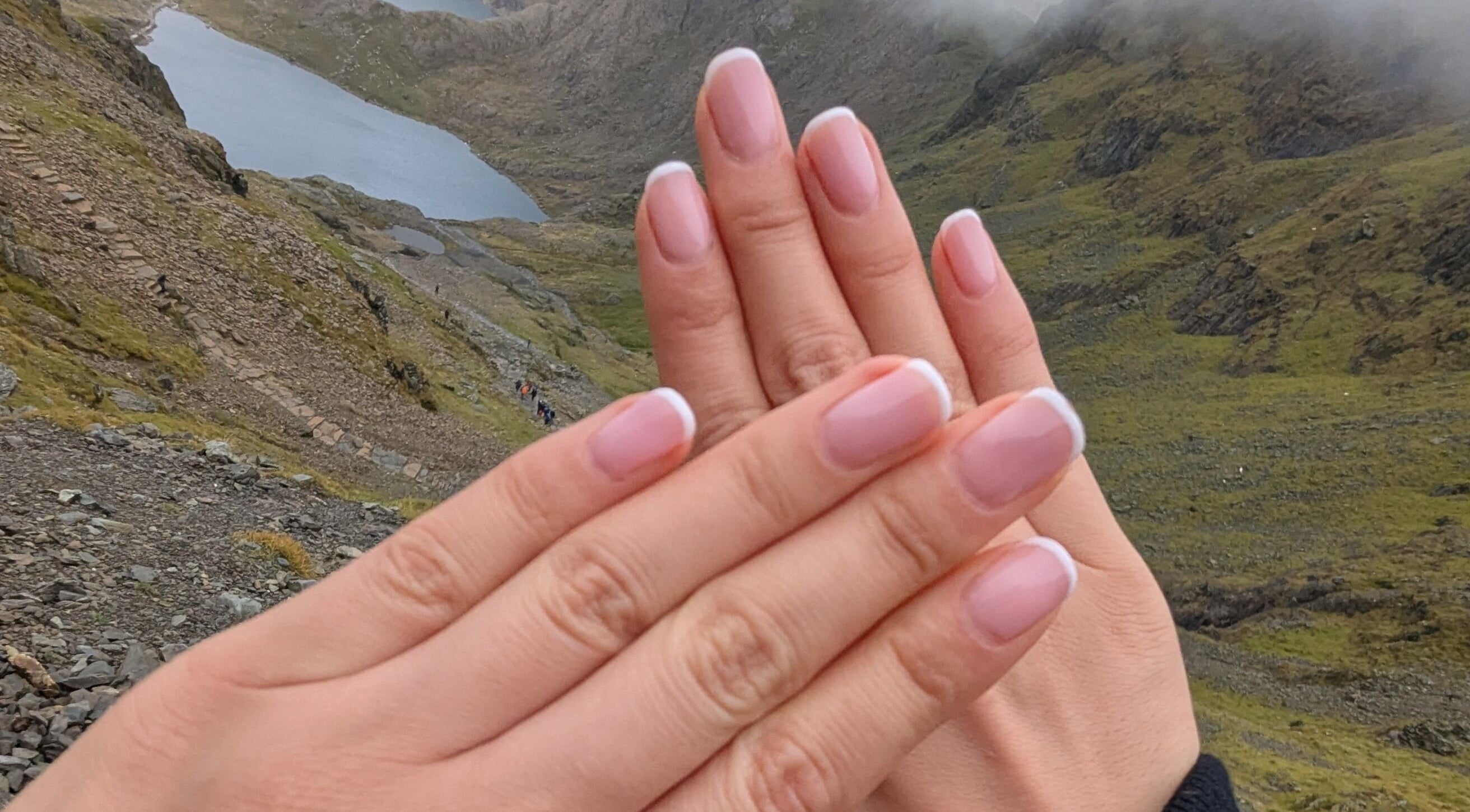 Beautifully manicured nails from Garden Nail Haven, Chester, England, GB, with scenic outdoor backdrop.