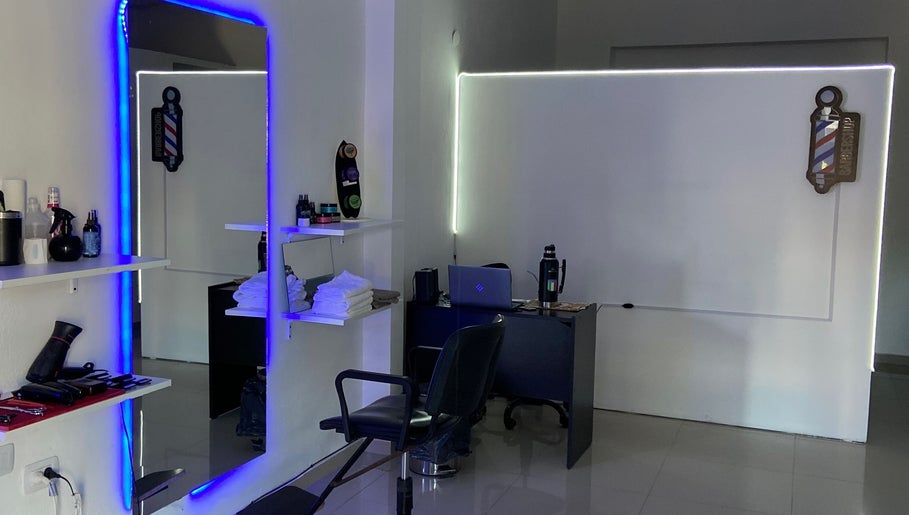 Interior moderno del salón Estilo Sosa en Rosario, Santa Fe, AR con espejo iluminado y estación de barbero.