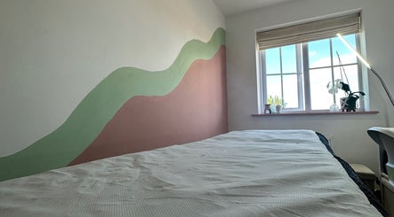Serene beauty room at 33 Beauty and Aesthetics, Ilkeston, England, GB with a calming wall mural and bright window.