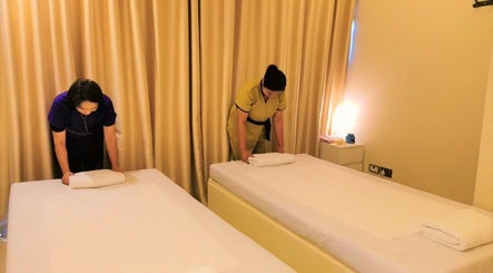 Staff prepares massage tables at Third Eye Peace Spa in Dubai, AE for a tranquil experience.