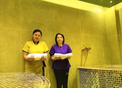 Two staff with towels at Third Eye Peace Spa, a serene retreat in Dubai, AE.
