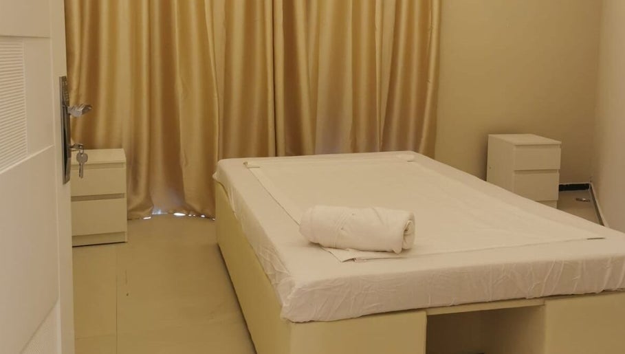 Peaceful massage room at Third Eye Peace Spa Al Jaddaf, Dubai, AE with soft lighting and a cozy bed.