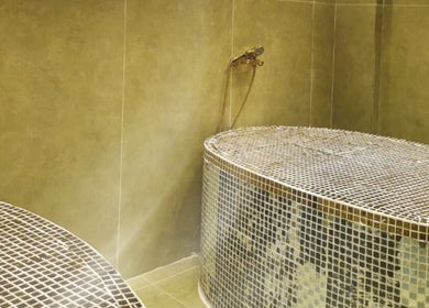 Luxurious spa room at Third Eye Peace Spa Al Jaddaf, Dubai, AE with mosaic-tiled hot stone tables.
