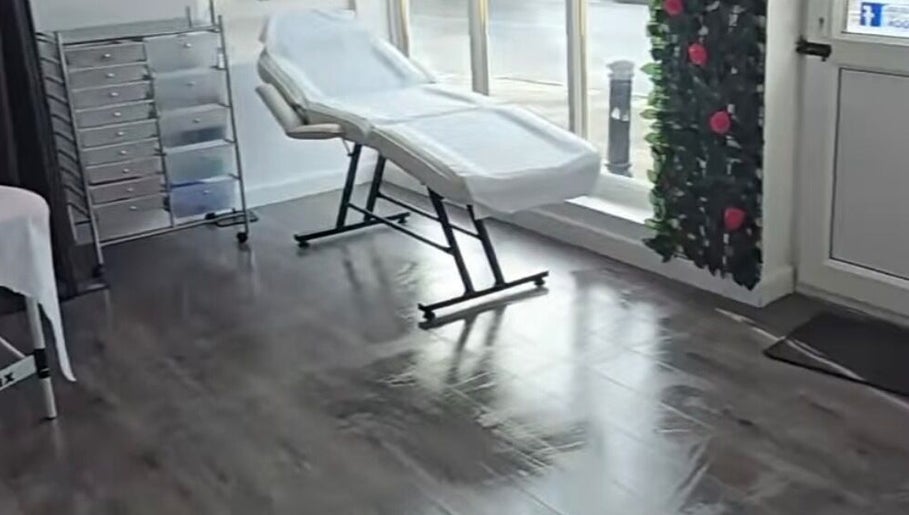 Tranquil treatment room at Beauty by Brittany, Sheffield, England, with a sleek reclining chair by a large window.