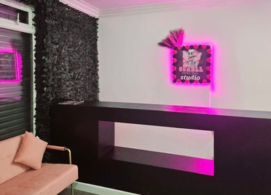 Modern reception area at Beauty by Brittany in Sheffield, England, GB, featuring sleek design and pink neon accents.