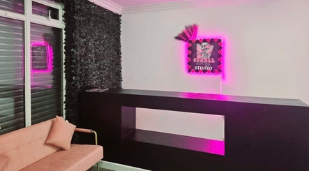 Modern reception area at Beauty by Brittany in Sheffield, England, GB, featuring sleek design and pink neon accents.