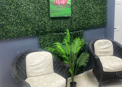 Chic seating area with green accents at Adams House of Aesthetics, Roseau, Saint George Parish, DM.