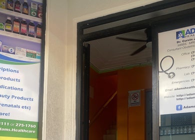 Entrance of Adams House of Aesthetics, Roseau, Saint George Parish, DM, displaying service offerings.