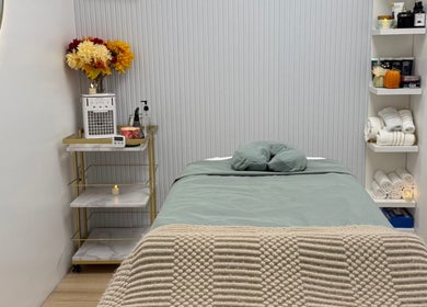 Serene treatment room at Aura Sanctuary, New York, New York, US with cozy bed and elegant decor.