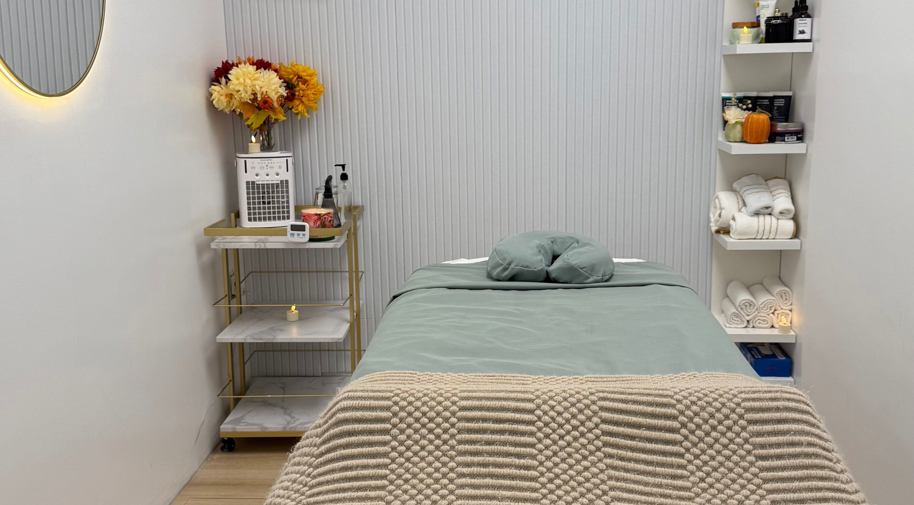 Relaxing massage room at Aura Sanctuary, New York, featuring cozy bed and elegant decor for ultimate wellness.